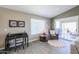 Bright living room with desk, sliding glass doors and comfortable chair at 2384 E Santiago Trl, Casa Grande, AZ 85194
