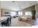 Open-concept living room featuring tile floors, neutral walls, and comfortable seating at 2384 E Santiago Trl, Casa Grande, AZ 85194