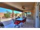 Covered patio with ceiling fan, outdoor furniture, and landscaped backyard at 2384 E Santiago Trl, Casa Grande, AZ 85194