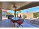 Covered patio with seating and landscaped backyard at 2384 E Santiago Trl, Casa Grande, AZ 85194