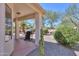 Charming covered patio with outdoor seating and grill in a landscaped backyard at 2464 E Hancock Trl, Casa Grande, AZ 85194