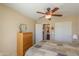 Relaxing bedroom with a ceiling fan, tiled flooring, a comfortable bed, and access to the ensuite bathroom and closet at 2464 E Hancock Trl, Casa Grande, AZ 85194
