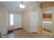 Bright entryway with tile flooring, neutral walls, and direct access to laundry room offers practical convenience at 2464 E Hancock Trl, Casa Grande, AZ 85194
