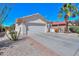 Single-story home with a desert landscaped front yard, spacious driveway, and a well-maintained two-car garage on a sunny day at 2464 E Hancock Trl, Casa Grande, AZ 85194