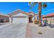 Inviting single-story home featuring desert landscaping, a two-car garage, and a well-maintained front yard with mature palm tree at 2464 E Hancock Trl, Casa Grande, AZ 85194