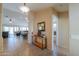Spacious foyer with tile flooring, decorative console table, and open access to the living room and hallway to the bedrooms at 2464 E Hancock Trl, Casa Grande, AZ 85194