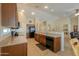 Spacious kitchen features tile floors, speckled granite countertops, recessed lights and dark wood cabinets at 2464 E Hancock Trl, Casa Grande, AZ 85194