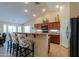 Kitchen with a peninsula, barstools, and modern appliances, perfect for casual dining and entertaining at 2464 E Hancock Trl, Casa Grande, AZ 85194