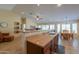Open kitchen features a peninsula, barstools, and seamless connection to the dining area and living room at 2464 E Hancock Trl, Casa Grande, AZ 85194