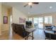 Comfortable living room with a ceiling fan, large windows, and seamless indoor-outdoor flow at 2464 E Hancock Trl, Casa Grande, AZ 85194