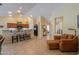 Inviting open-concept living area with bar seating, recessed lighting, and access to the kitchen at 2464 E Hancock Trl, Casa Grande, AZ 85194