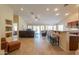 Expansive living room with bar seating, recessed lighting, and seamless flow into adjacent spaces at 2464 E Hancock Trl, Casa Grande, AZ 85194