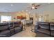 Open-concept space with bar, kitchen, and living areas provides ample room for relaxing and entertaining at 2464 E Hancock Trl, Casa Grande, AZ 85194