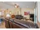 Spacious living room showcasing comfortable seating, a ceiling fan, and modern decor for relaxed living at 2464 E Hancock Trl, Casa Grande, AZ 85194