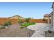 Well-maintained backyard featuring desert landscaping, artificial turf, gravel and a travertine patio at 25920 W Westcott Dr, Buckeye, AZ 85396