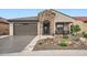 Charming home featuring desert landscaping, stone accents, and a welcoming covered porch at 25920 W Westcott Dr, Buckeye, AZ 85396