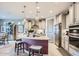 Modern kitchen with stainless steel appliances, stylish island, and pendant lighting at 25920 W Westcott Dr, Buckeye, AZ 85396