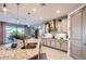 Bright kitchen with granite countertops, stainless appliances, and an island with pendant lighting at 25920 W Westcott Dr, Buckeye, AZ 85396