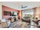 Cozy living room with a modern ceiling fan, stylish furniture, and lots of natural light at 25920 W Westcott Dr, Buckeye, AZ 85396