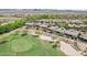 Beautiful aerial view of houses near a lush green golf course with mountain views in the distance at 27688 N 125Th Dr, Peoria, AZ 85383