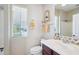 Bathroom featuring modern fixtures, including a stylish sink and faucet and a window for natural light at 27688 N 125Th Dr, Peoria, AZ 85383