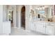Bright bathroom with granite countertops, white cabinets, and a step-in shower with glass enclosure at 27688 N 125Th Dr, Peoria, AZ 85383