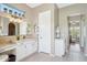 Bright bathroom with granite countertops, white cabinets, and a vanity area with stool at 27688 N 125Th Dr, Peoria, AZ 85383