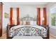 Inviting main bedroom featuring a decorative bed frame, two windows, and hardwood floors at 27688 N 125Th Dr, Peoria, AZ 85383
