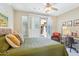 Bedroom features a bed with patio access, opening to an outdoor seating area at 27688 N 125Th Dr, Peoria, AZ 85383