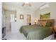 Bedroom features a bed with an ensuite bathroom and office nook, with ceiling fan at 27688 N 125Th Dr, Peoria, AZ 85383