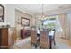 Cozy dining room featuring rustic furniture, warm lighting, and backyard views at 27688 N 125Th Dr, Peoria, AZ 85383