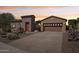 Charming single-story home with a stone accent wall, three-car garage, and desert landscaping at 27688 N 125Th Dr, Peoria, AZ 85383