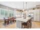 Charming eat-in kitchen with custom cabinetry, granite countertops, a large center island and tile flooring at 27688 N 125Th Dr, Peoria, AZ 85383