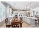 Lovely kitchen with custom cabinetry, granite countertops, stainless steel appliances, and a breakfast nook at 27688 N 125Th Dr, Peoria, AZ 85383