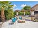 Outdoor kitchen with built-in grill, fire pit, and comfortable seating area at 27688 N 125Th Dr, Peoria, AZ 85383