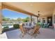 Covered patio with dining table and a view of the pool and backyard at 27688 N 125Th Dr, Peoria, AZ 85383