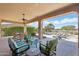 Expansive covered patio overlooking a pool and lush landscaping at 27688 N 125Th Dr, Peoria, AZ 85383