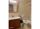 A well-lit bathroom featuring a wooden framed mirror, toilet, sink and a shower-tub combo at 3339 W Shaw Butte Dr, Phoenix, AZ 85029