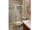 Clean bathroom featuring a glass shower door, toilet, sink and a wood framed mirror at 3339 W Shaw Butte Dr, Phoenix, AZ 85029