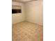 Neutral bedroom showcasing tile flooring, a window, and base trim along the wall at 3339 W Shaw Butte Dr, Phoenix, AZ 85029