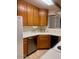 Functional kitchen features a stainless-steel dishwasher, oak cabinets, and tile flooring at 3339 W Shaw Butte Dr, Phoenix, AZ 85029