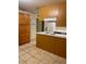 Functional kitchen features oak cabinets, tile flooring, and ample counter space at 3339 W Shaw Butte Dr, Phoenix, AZ 85029