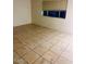 Neutral colored living room features durable tile flooring and a window with adjustable blinds, perfect for any design style at 3339 W Shaw Butte Dr, Phoenix, AZ 85029