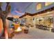 Stylish outdoor backyard featuring an outdoor kitchen, a fire pit, and covered seating area at 3675 N 59Th Pl, Phoenix, AZ 85018