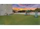 Expansive backyard with lush artificial turf and a fun playset, offering a safe and enjoyable space for  at 3675 N 59Th Pl, Phoenix, AZ 85018