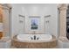 Luxurious bathtub with elegant architectural details and natural stone at 3675 N 59Th Pl, Phoenix, AZ 85018