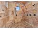 Luxurious walk-in shower featuring dual shower heads, custom tile and in-shower bench at 3675 N 59Th Pl, Phoenix, AZ 85018