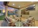 Charming covered patio with elegant seating, an outdoor TV, and lush landscaping offering a relaxing retreat at 3675 N 59Th Pl, Phoenix, AZ 85018