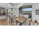 Elegant dining room features modern lighting and views of the outdoor pool area at 3675 N 59Th Pl, Phoenix, AZ 85018