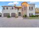Stunning two-story home featuring a stone tower, two-car garage, and beautiful desert landscaping at 3675 N 59Th Pl, Phoenix, AZ 85018